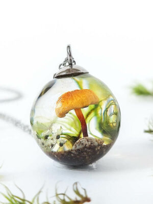 Resin mushroom pendant surrounded by moss