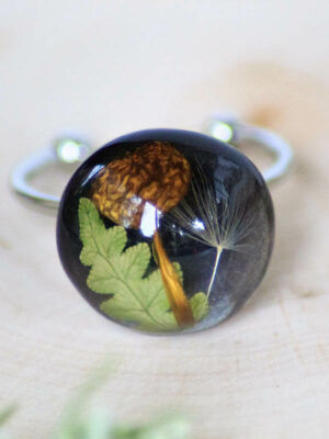 Adjustable ring with mushroom, leaf, and dandelion seed encapsulated in resin
