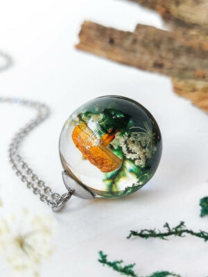 Pendant with mushroom and moss inside resin, side view