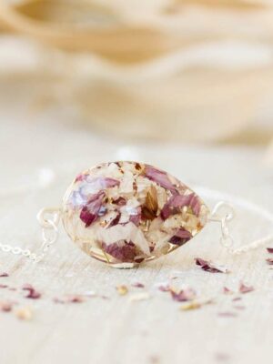 Delicate memorial bracelet featuring preserved funeral flower petals in purple and beige tones