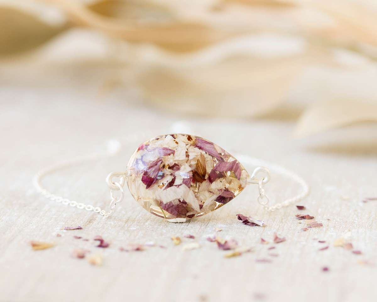 Delicate memorial bracelet featuring preserved funeral flower petals in purple and beige tones