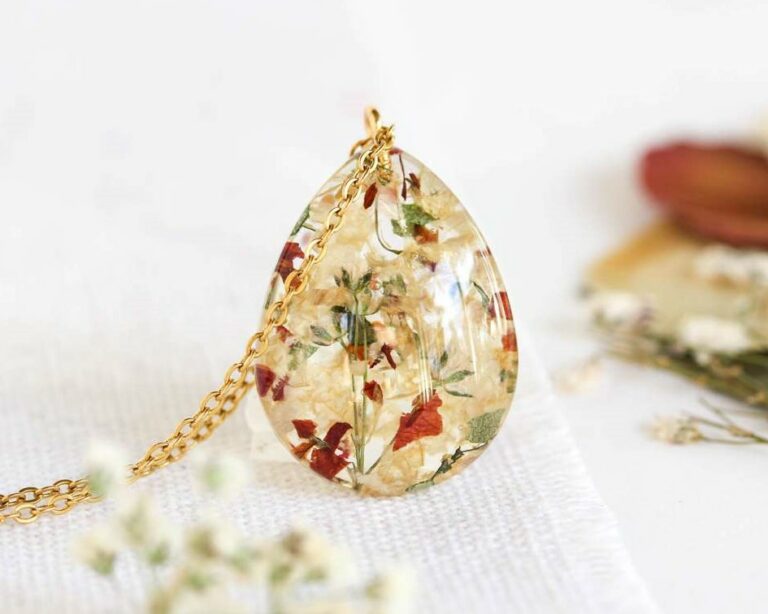 Personalized teardrop resin pendant handcrafted with real funeral flowers preserved in clear resin.