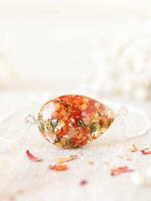 Delicate bridal flower bracelet in a teardrop shape, handcrafted with real dried petals and greenery from a wedding bouquet.
