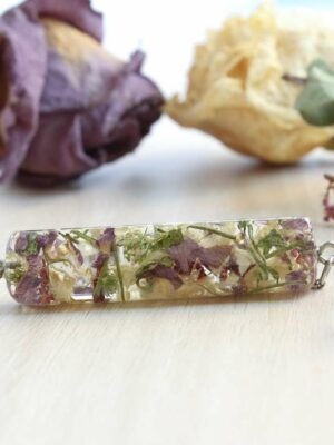 Personalized necklace showcasing dried bridal flowers inside a rectangular resin pendant, a unique wedding memento.