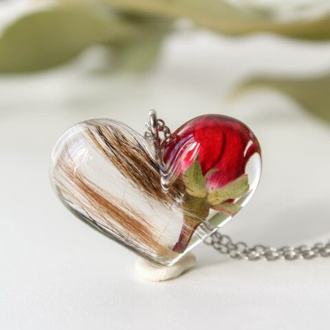 Heart-shaped resin necklace with preserved rose and pet fur, sentimental custom memorial jewelry.